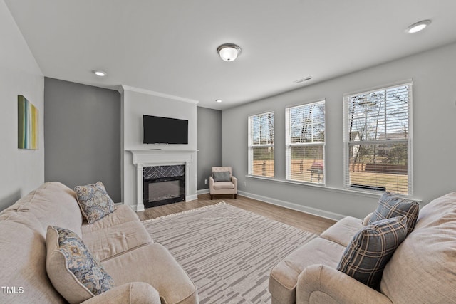 1408 Weavers Trace Dr, Zebulon, NC 27597 - living room featuring recessed lighting, baseboards, a fireplace, and wood finished floors