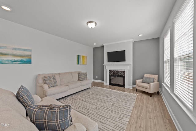 1408 Weavers Trace Dr, Zebulon, NC 27597 - living area with recessed lighting, a glass covered fireplace, baseboards, and light wood-type flooring