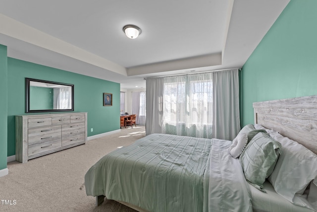 1408 Weavers Trace Dr, Zebulon, NC 27597 - carpeted bedroom featuring a raised ceiling and baseboards