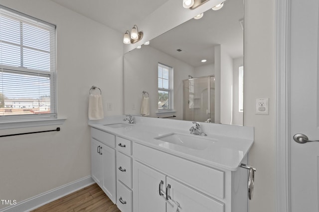 1408 Weavers Trace Dr, Zebulon, NC 27597 - bathroom featuring a stall shower, baseboards, double vanity, and a sink