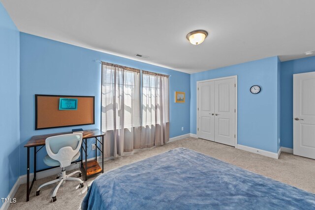 1408 Weavers Trace Dr, Zebulon, NC 27597 - bedroom featuring a closet, baseboards, visible vents, and carpet