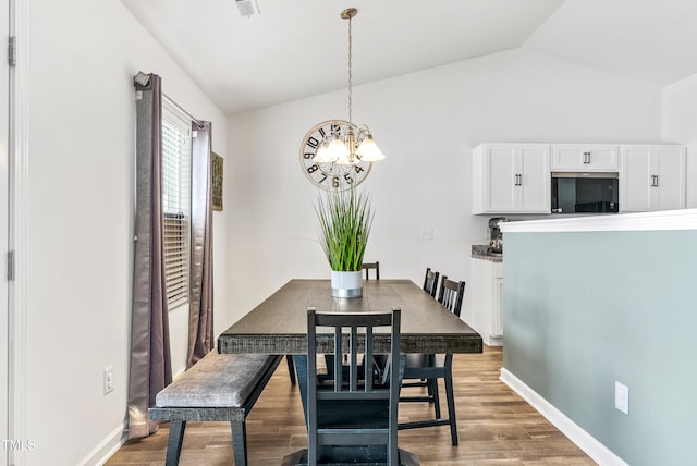 1004 Gold Cir, Mebane, NC 27302 - dining room with baseboards, vaulted ceiling, wood finished floors, and a notable chandelier