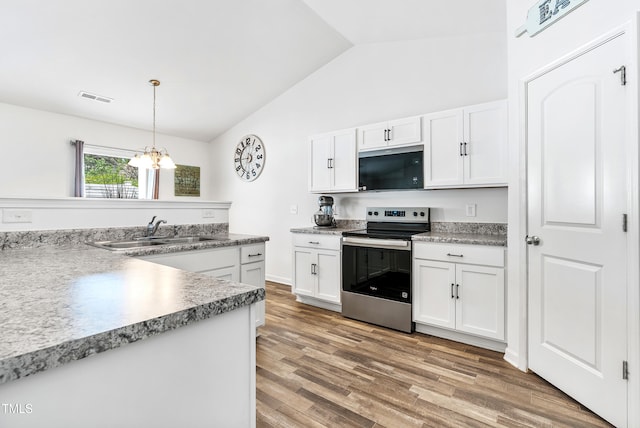 1004 Gold Cir, Mebane, NC 27302 - kitchen with visible vents, vaulted ceiling, stainless steel electric range, a sink, and a chandelier