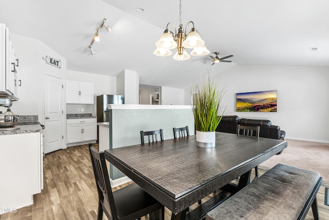1004 Gold Cir, Mebane, NC 27302 - dining space with visible vents, light wood-style flooring, ceiling fan with notable chandelier, and lofted ceiling