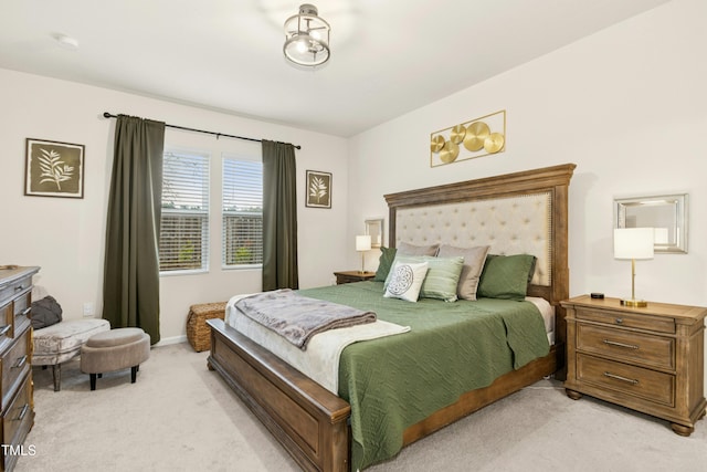 bedroom with baseboards and light colored carpet