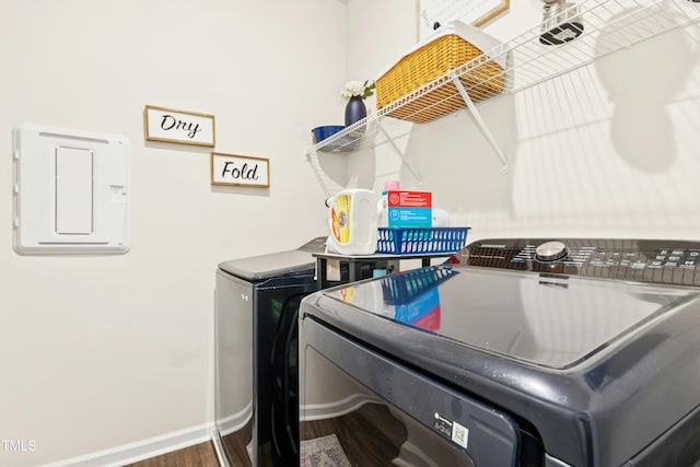 laundry room with baseboards, wood finished floors, laundry area, and washer and clothes dryer