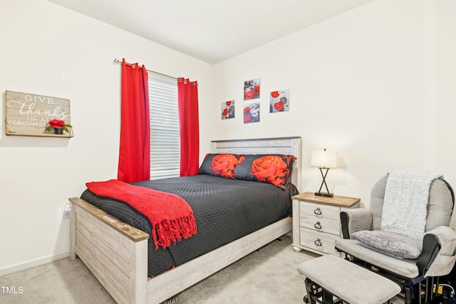 bedroom featuring baseboards and carpet