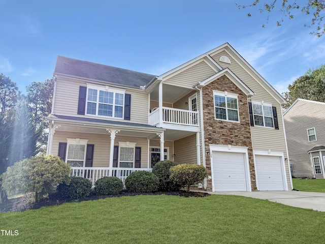 view of front of home featuring an attached garage, driveway, a porch, and a front lawn