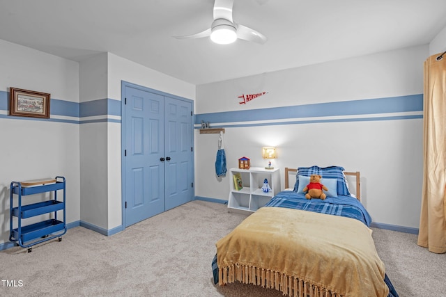 bedroom with carpet floors, a closet, baseboards, and ceiling fan