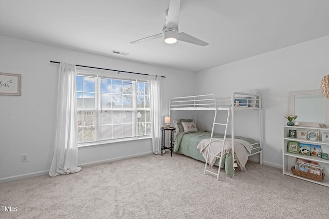 bedroom with baseboards, a ceiling fan, visible vents, and carpet
