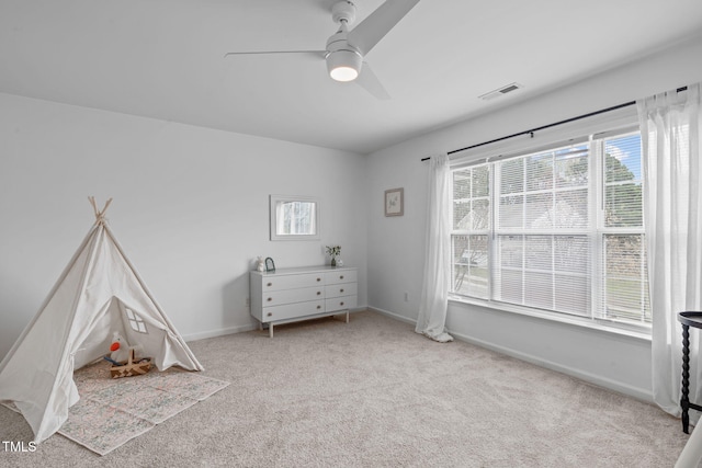 playroom with baseboards, a ceiling fan, visible vents, and carpet floors