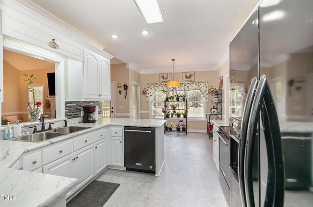 608 Adler Ln, Goldsboro, NC 27530 - kitchen with crown molding, a peninsula, dishwasher, a sink, and fridge with ice dispenser