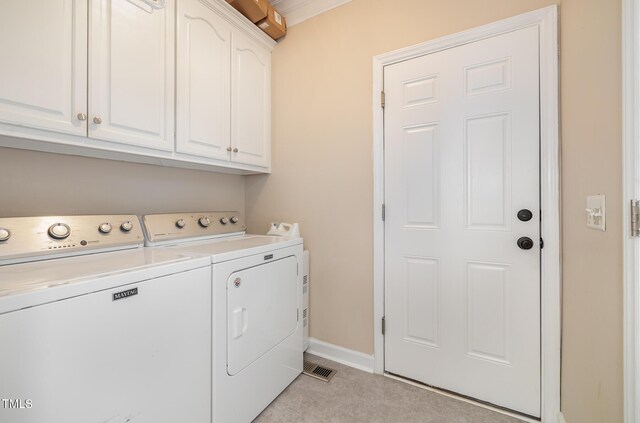 608 Adler Ln, Goldsboro, NC 27530 - clothes washing area featuring baseboards, cabinet space, and separate washer and dryer