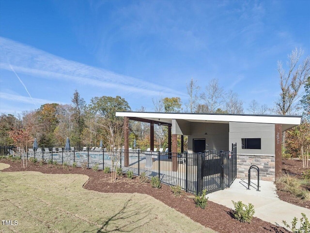 view of home's community with fence and an attached carport