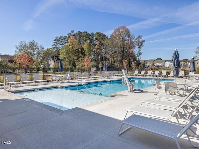 pool featuring a patio area and fence