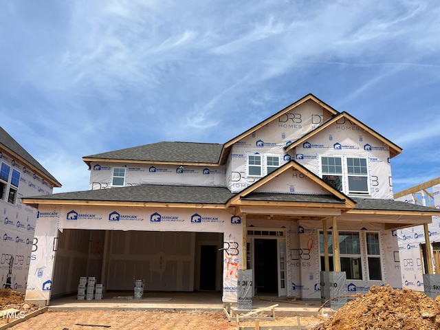 property under construction with a garage and a shingled roof