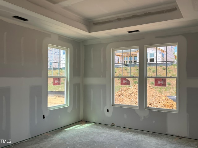 unfurnished room with visible vents