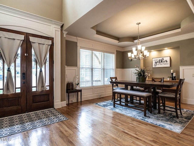 107 Bella Casa Way, Clayton, NC 27527 - dining space with a raised ceiling, a notable chandelier, and wood finished floors