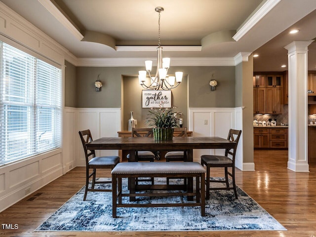 107 Bella Casa Way, Clayton, NC 27527 - dining area with a decorative wall, a chandelier, decorative columns, dark wood-type flooring, and a tray ceiling