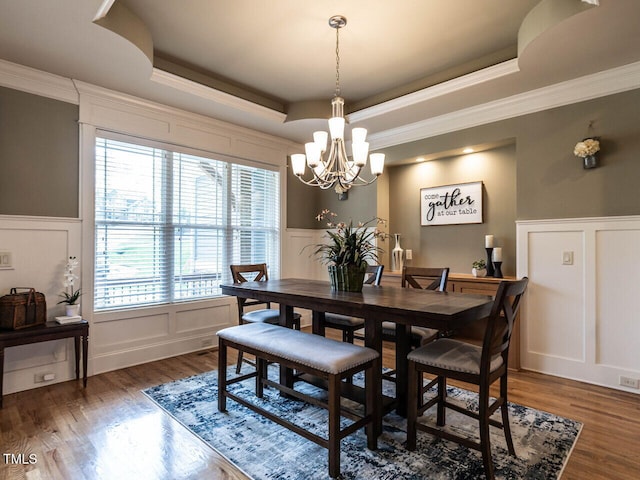 107 Bella Casa Way, Clayton, NC 27527 - dining area with a tray ceiling, a decorative wall, an inviting chandelier, and wood finished floors