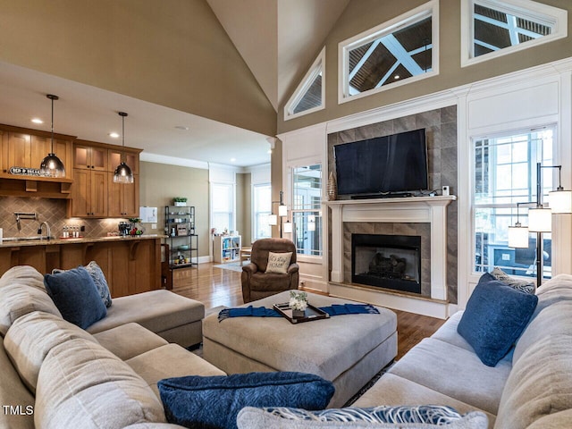 107 Bella Casa Way, Clayton, NC 27527 - living area with plenty of natural light, a tile fireplace, high vaulted ceiling, and wood finished floors