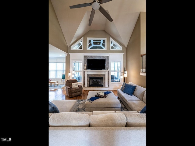 107 Bella Casa Way, Clayton, NC 27527 - living room with a fireplace, wood finished floors, vaulted ceiling, and a ceiling fan