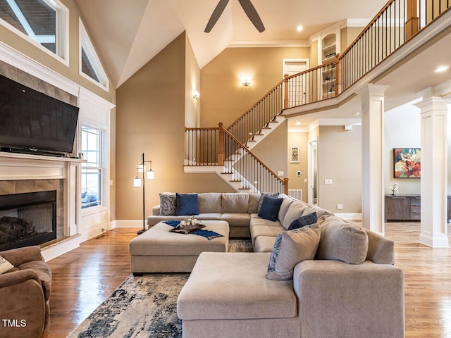 107 Bella Casa Way, Clayton, NC 27527 - living area featuring a towering ceiling, wood finished floors, ceiling fan, and stairway
