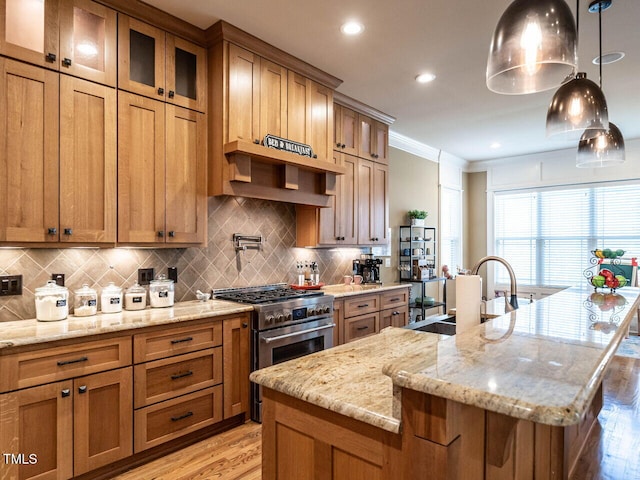 107 Bella Casa Way, Clayton, NC 27527 - kitchen featuring an island with sink, crown molding, a sink, high end range, and brown cabinetry