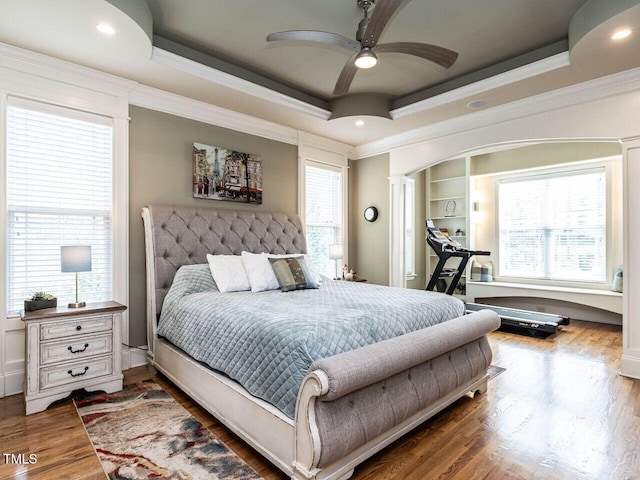 107 Bella Casa Way, Clayton, NC 27527 - bedroom featuring a tray ceiling, wood finished floors, multiple windows, and crown molding