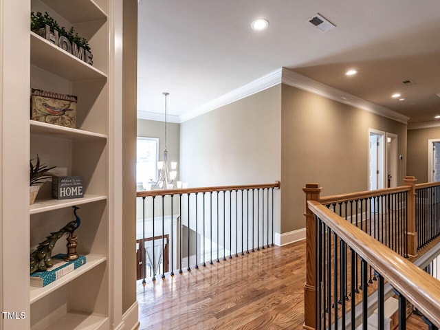 107 Bella Casa Way, Clayton, NC 27527 - corridor featuring an upstairs landing, visible vents, wood finished floors, recessed lighting, and an inviting chandelier