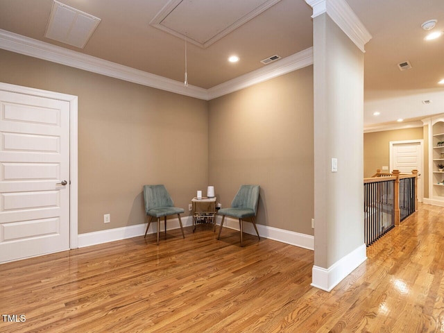 107 Bella Casa Way, Clayton, NC 27527 - living area featuring visible vents, baseboards, ornamental molding, attic access, and light wood-style floors