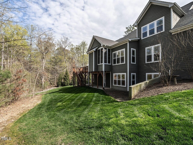 107 Bella Casa Way, Clayton, NC 27527 - view of home's exterior featuring a lawn, a shingled roof, stairway, and a deck