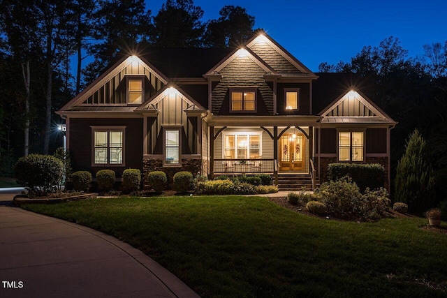 107 Bella Casa Way, Clayton, NC 27527 - craftsman-style home featuring stone siding, a porch, board and batten siding, and a yard