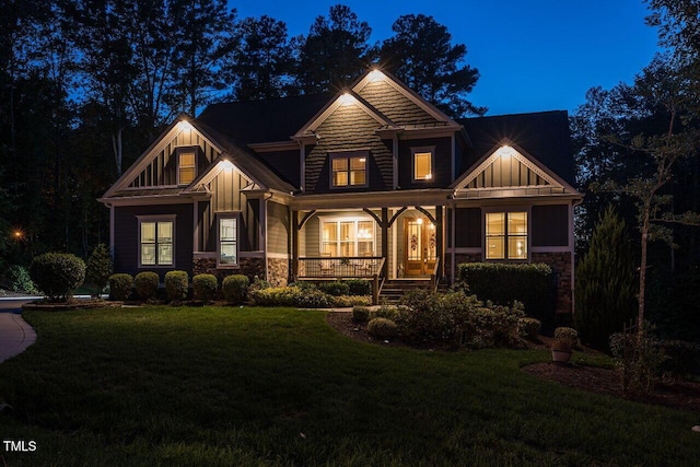 107 Bella Casa Way, Clayton, NC 27527 - view of front of property with stone siding, board and batten siding, covered porch, and a front lawn