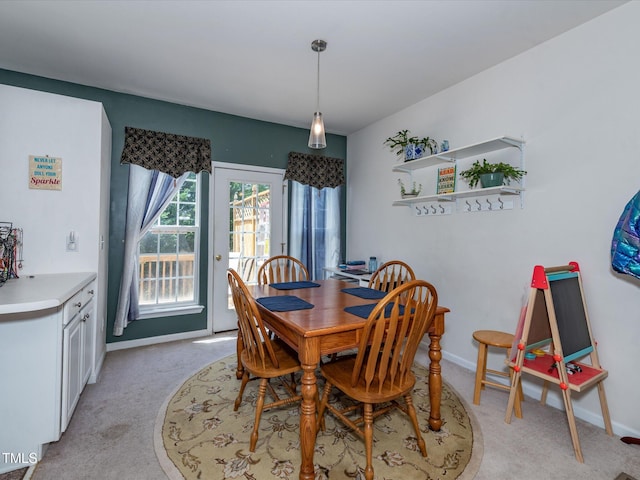 dining room with light carpet and baseboards