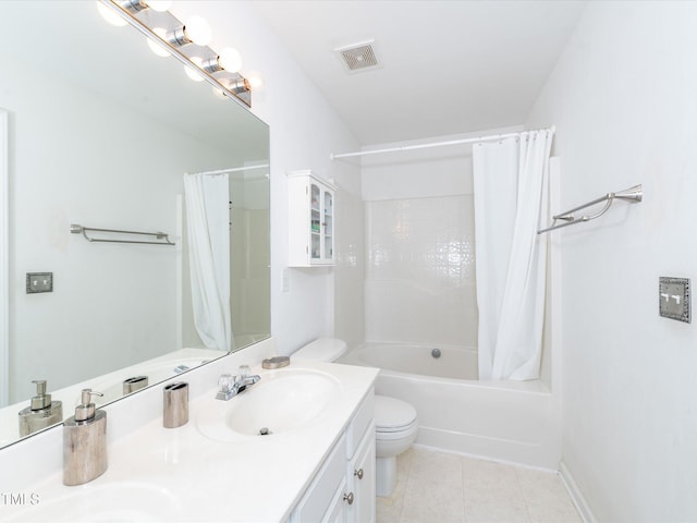 bathroom with tile patterned floors, double vanity, toilet, and shower / bath combo