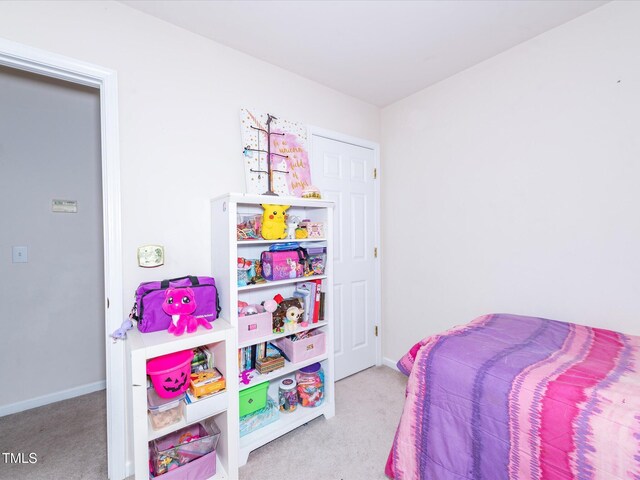 carpeted bedroom featuring baseboards
