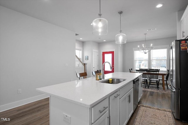 305 Wash Hollow Dr, Wendell, NC 27591 - kitchen with dark wood-type flooring, baseboards, a sink, white cabinets, and appliances with stainless steel finishes