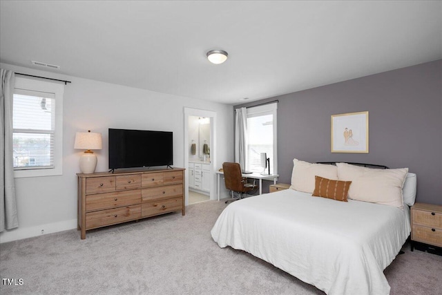 305 Wash Hollow Dr, Wendell, NC 27591 - carpeted bedroom featuring baseboards, ensuite bath, multiple windows, and visible vents
