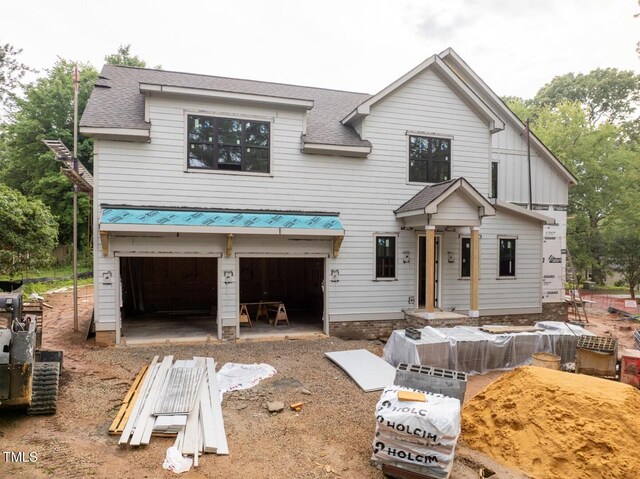 5107 Hearth Dr, Raleigh, NC 27609 - modern farmhouse style home with an attached garage, roof with shingles, and board and batten siding