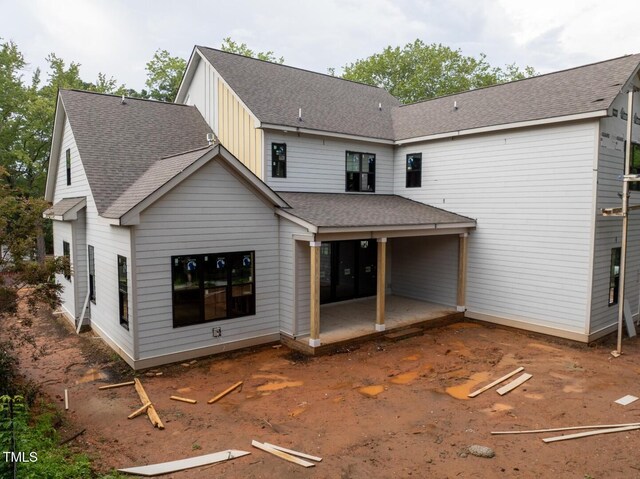 5107 Hearth Dr, Raleigh, NC 27609 - rear view of house featuring a patio area, board and batten siding, and roof with shingles