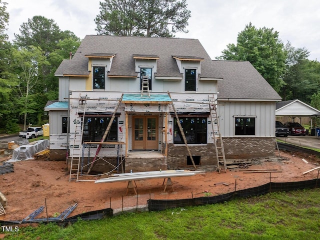 5107 Hearth Dr, Raleigh, NC 27609 - back of property featuring roof with shingles, brick siding, board and batten siding, and french doors