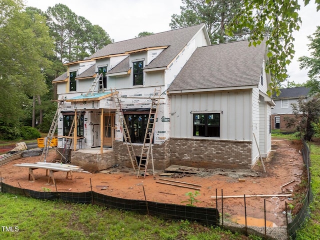 5107 Hearth Dr, Raleigh, NC 27609 - view of front of home with a shingled roof, brick siding, board and batten siding, stairway, and a patio