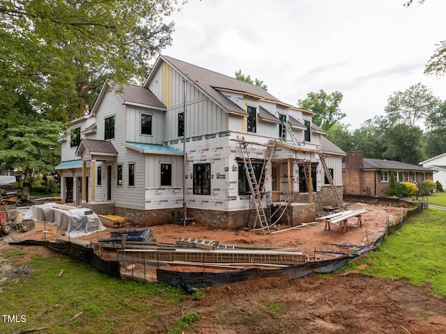 5107 Hearth Dr, Raleigh, NC 27609 - back of house with board and batten siding and a shingled roof
