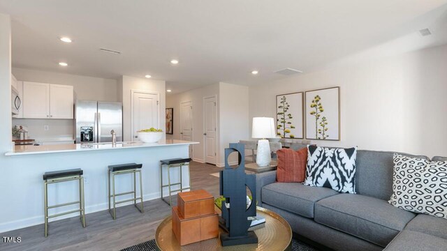 146 Holton St, Smithfield, NC 27577 - living area featuring baseboards, wood finished floors, and recessed lighting