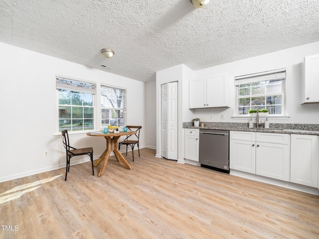 106 Mingocrest Dr, Knightdale, NC 27545 - kitchen with white cabinets, light wood finished floors, dishwasher, dark stone counters, and a sink
