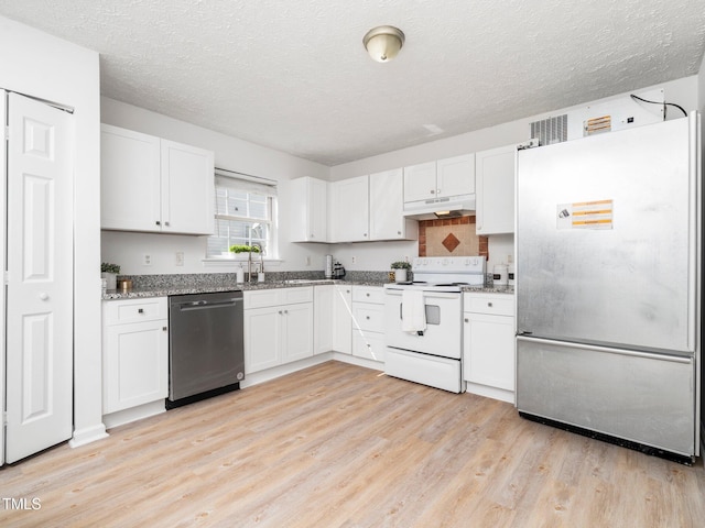 106 Mingocrest Dr, Knightdale, NC 27545 - kitchen with light wood-style flooring, stainless steel appliances, under cabinet range hood, stone countertops, and white cabinets