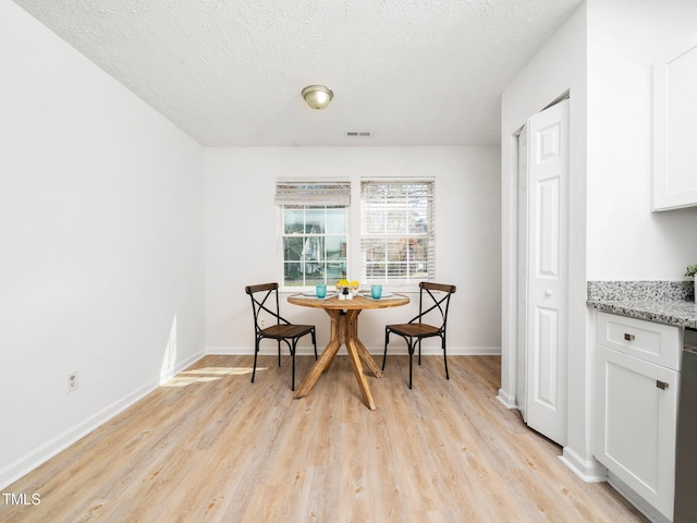 106 Mingocrest Dr, Knightdale, NC 27545 - dining space with a textured ceiling, breakfast area, light wood finished floors, and visible vents