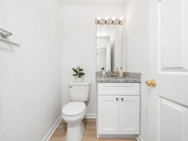 106 Mingocrest Dr, Knightdale, NC 27545 - bathroom featuring toilet, vanity, baseboards, and wood finished floors