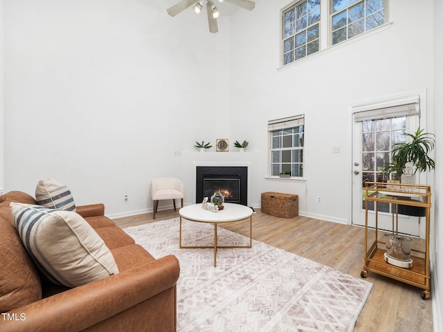 106 Mingocrest Dr, Knightdale, NC 27545 - living room with a glass covered fireplace, baseboards, ceiling fan, and wood finished floors